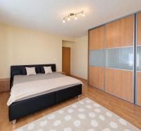 A children's room with pink curtains and a wooden decor floor in a 3-room apartment.