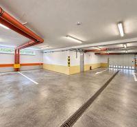 Parking spaces in a closed garage, Bratislava - Ružinov, with orange details and stripes.