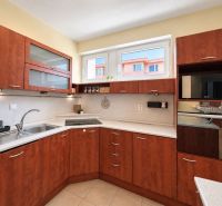 Bedroom in a 3-room apartment with a double bed, a large wardrobe, and a floor with a wooden decor.