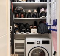 Storage space with shelves for shoes and a washing machine in a 3-room apartment.