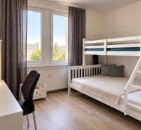Children in a 3-room apartment. Bunk bed, writing desk, floor with wooden decor.