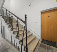 Stairwell area next to the entrance door of a 2-room apartment with decorative railing.