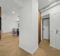 Interior of a 2-room apartment with a wooden decor floor and stylish furnishings.