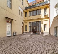 Panská Street, Bratislava - Old Town: courtyard of offices with paving and historical building facade.