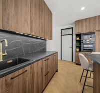 A kitchen in a 2-room apartment with wooden cabinets and a floor with a wooden decor.