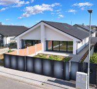 A family house on Cífer Street in Trnava with large windows and a garden behind the fence.