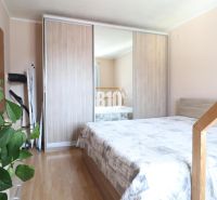 A bedroom with a double bed and a built-in wardrobe in a 3-room apartment.