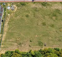 A top-down view of development plots near Borinka with a nearby building and greenery.