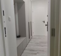 A hallway in a 3-room apartment with white door frames and a built-in wardrobe.