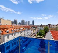 View from the balcony onto the streets of Bratislava - Old Town with high-rise buildings in the background.