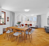 Living room with a kitchenette, dining table, and wooden decor flooring in a 3-room apartment.