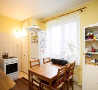 Kitchen in a 3-room apartment with a table, chairs, and a kitchen unit.