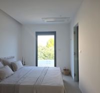 Bright bedroom in a 4-room apartment with a view, the bed is made.