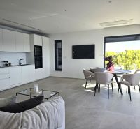 A spacious living room with a light interior and a dining area in a 4-room apartment.