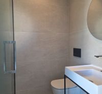 A bathroom with a shower and a sink in a 4-room apartment.