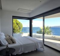 A bedroom in a 4-room apartment with a sea view and a balcony.