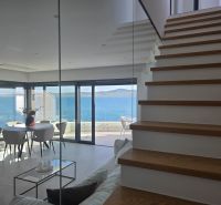 Interior of a 4-room apartment with a sea view, stairs with wooden decor.