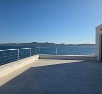 A terrace with a view of the sea and surrounding countryside in Sukošan at a 4-room apartment.