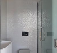 Bathroom with a shower and toilet in a 4-room apartment, simple and clean design.