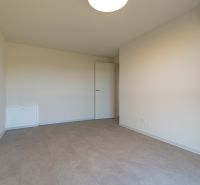 An empty room in a 4-room apartment with beige walls and air conditioning.
