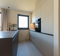 A kitchen in a 4-room apartment with modern appliances and light furniture.