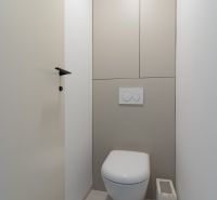 A toilet with a concealed flushing system in a 4-room apartment.