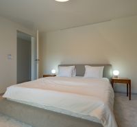 A bedroom in a 4-room apartment with a comfortable bed and nightstands.