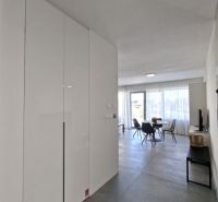 A hallway with tiles and a built-in wardrobe in a 2-room apartment.