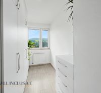 A bright room with white furniture and a wooden decor floor in a 2-room apartment.