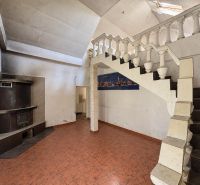 Interior with a tiled fireplace, staircase, and flooring, suitable for residential plots.