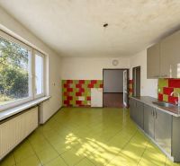 A kitchen with colorful tiles, green flooring, and a wooden decor floor, Properties - living.