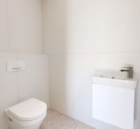 Bathroom with toilet and sink in a 3-room apartment.