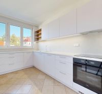 A kitchen with built-in appliances and plenty of storage space in a 3-room apartment.