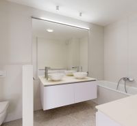 A bathroom with a large mirror, a bathtub, and a double sink in a 3-room apartment.