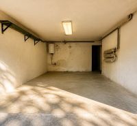 Garage in the Cottage on Rekreačná Street in Vrbové with a concrete floor and lighting.