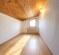 The interior of a cabin with a wooden decor floor and a wooden ceiling.