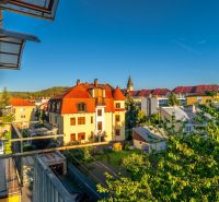View from the balcony of a 2-room apartment on Fučíkova Street in Bardejov with a view of the rooftops.