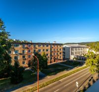 A view of residential buildings on Fučíkova Street in Bardejov on a sunny day.