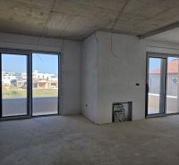 Interior of a 3-room apartment with large windows and a view of the outdoor construction.
