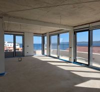 The view from a 3-room apartment in Sukošan of the sea through large windows.