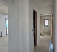 Interior of a 3-room apartment with unfinished walls and floor, ready for completion.