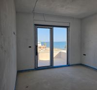 A room in a 3-room apartment with a sea view, without flooring.