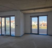 Interior of a 3-room apartment with large windows and a balcony offering a view.