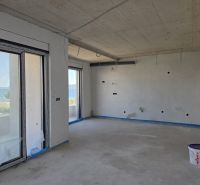 An empty interior of a 3-room apartment with a sea view, wooden decor flooring.