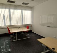 Offices with carpeted floors, desks, red chairs, and a whiteboard.
