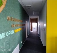 A hallway in offices with colorful walls and a motivational quote.
