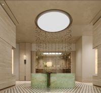 Reception in an apartment building with light decor and decorative curtains.
