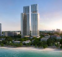 Apartment construction in Pattaya with a view of the beach and ocean.