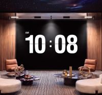 An interior space with clocks, sofas, and coffee tables as part of apartment construction.
