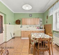 A kitchen in a family house with a simple interior and a floor with a wooden decor.